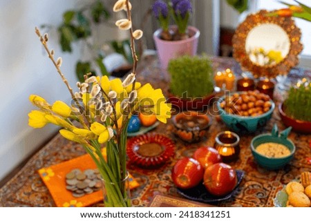 Haft Seen traditional table of Nowruz. Haft-Seen also spelled as Haft Sin is a tabletop (sofreh) arrangement of seven symbolic items traditionally displayed at Nowruz, the Iranian new year. Royalty-Free Stock Photo #2418341251