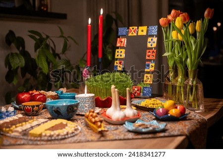 Haft Seen traditional table of Nowruz. Haft-Seen also spelled as Haft Sin is a tabletop (sofreh) arrangement of seven symbolic items traditionally displayed at Nowruz, the Iranian new year. Royalty-Free Stock Photo #2418341277