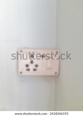 Defocuse wall socket with blurred background. Black and white 