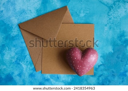 Heart and envelope on blue background, valentines day concept.