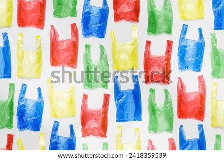 Minimal pattern of bright colorful plastic bags on light background, Biodegradable packaging waste, Disposable bag for grocery or garbage, bag free day. Polythene packets. Plastic free concept