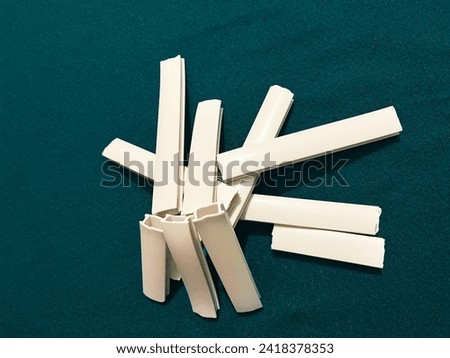 A vibrant photograph showcasing neatly arranged PVC pipes on a bright blue background, creating an interesting and visually appealing pattern