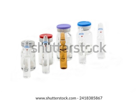 Glass medical ampoule vials for injection. Medicine is dry white drug penicillin powder or liquid with of aqueous solution in ampulla. Royalty-Free Stock Photo #2418385867