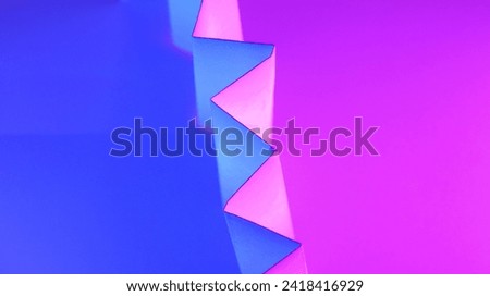 Paper colored with blue and purple light as an abstract background