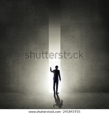 Rear view of businessman standing in light of way