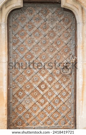 Old weathered metal door somewhere in the Castle. Antique iron forged door in the castle