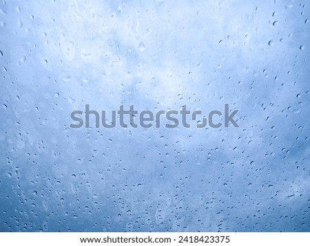 View of glass window with rain water drops, blurred pictures.