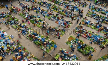 Aerial view of busy local daily life of the morning local market in Vi Thanh or Chom Hom market, Vietnam. People can seen exploring around the market. Royalty-Free Stock Photo #2418432011