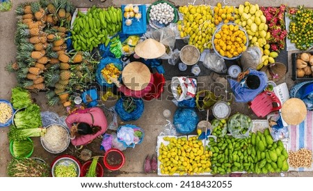 Aerial view of busy local daily life of the morning local market in Vi Thanh or Chom Hom market, Vietnam. People can seen exploring around the market. Royalty-Free Stock Photo #2418432055