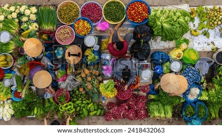 Aerial view of busy local daily life of the morning local market in Vi Thanh or Chom Hom market, Vietnam. People can seen exploring around the market. Royalty-Free Stock Photo #2418432063