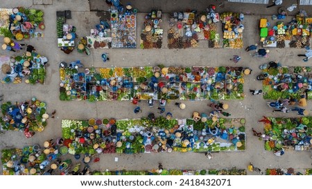 Aerial view of busy local daily life of the morning local market in Vi Thanh or Chom Hom market, Vietnam. People can seen exploring around the market. Royalty-Free Stock Photo #2418432071