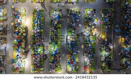 Aerial view of busy local daily life of the morning local market in Vi Thanh or Chom Hom market, Vietnam. People can seen exploring around the market. Royalty-Free Stock Photo #2418432135