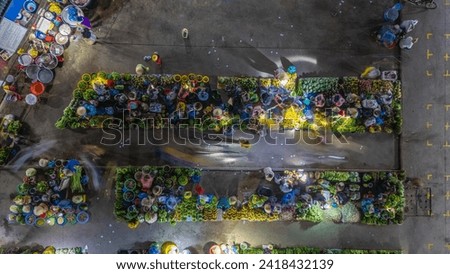 Aerial view of busy local daily life of the morning local market in Vi Thanh or Chom Hom market, Vietnam. People can seen exploring around the market. Royalty-Free Stock Photo #2418432139