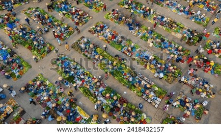 Aerial view of busy local daily life of the morning local market in Vi Thanh or Chom Hom market, Vietnam. People can seen exploring around the market. Royalty-Free Stock Photo #2418432157