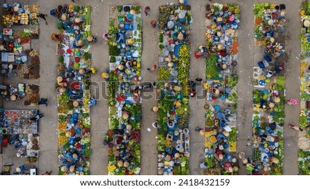 Aerial view of busy local daily life of the morning local market in Vi Thanh or Chom Hom market, Vietnam. People can seen exploring around the market. Royalty-Free Stock Photo #2418432159