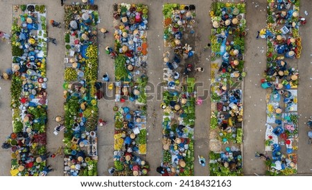 Aerial view of busy local daily life of the morning local market in Vi Thanh or Chom Hom market, Vietnam. People can seen exploring around the market. Royalty-Free Stock Photo #2418432163
