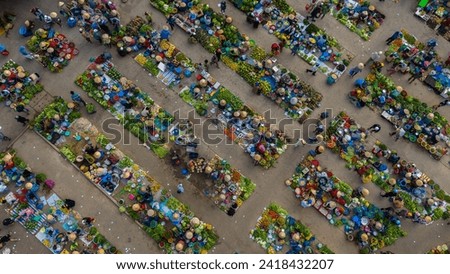 Aerial view of busy local daily life of the morning local market in Vi Thanh or Chom Hom market, Vietnam. People can seen exploring around the market. Royalty-Free Stock Photo #2418432207
