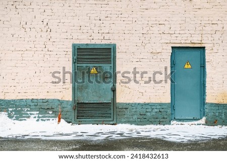 Doors with Electrical Hazard Signs Brick Wall