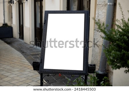 Restaurant sidewalk chalkboard sign board. Blank store signage sign design. White mock up of blank cafe menu stand on a sidewalk outdoors