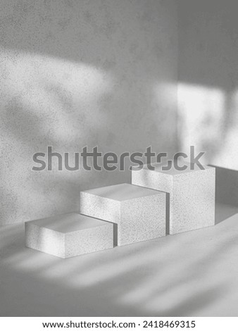 Modern allure: Three-tiered white platforms with black specks on concrete. Soft window light. Ideal for creative product placement, embodying sleek elegance in your brand story. Royalty-Free Stock Photo #2418469315