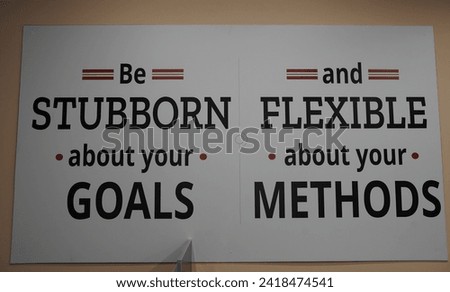Be stubborn and flexible about your goals and methods. Motivational quote on the wall.                