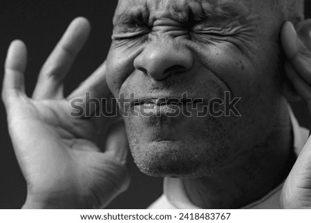 hearing loss deafness suffering hard of hearing on grey black background with people stock image stock photo	