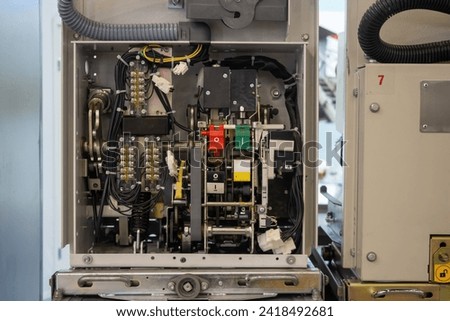 Electrical equipment inside. Disassembled machine control panel. Electrical appliance been opened for repair. Industrial equipment been dismantled for repairs. Wires and adapters inside metal cabinet Royalty-Free Stock Photo #2418492681