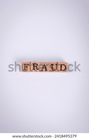 The inscription Fraud inspection made of wooden cubes on a plain background. Can be used for your design