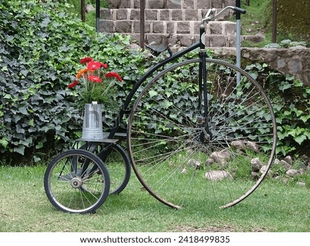 Old bicycle in decorative shape with flowers in a beautiful garden in Antigua Guatemala.