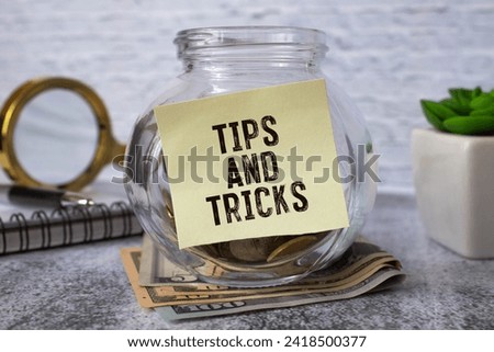 Tips And Tricks concept on desktop workspace with office supplies.