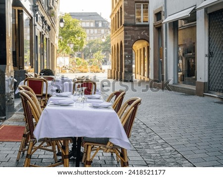 Experience fine dining on a luxury restaurant terrace in Strasbourg, perfectly laid out for an elegant outdoor meal Royalty-Free Stock Photo #2418521177