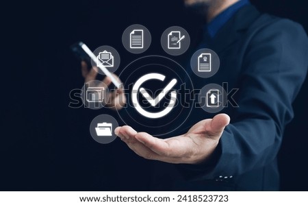 Businessman using smartphone with virtual correct sign or tick mark with document icon for approve quality assurance and guarantee concept, online approve paperless and quality assurance concept.