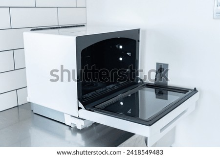 Microwave in an unattended kitchen Royalty-Free Stock Photo #2418549483