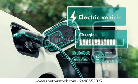 Electric car plug into EV charger cable from charging station display smart digital battery status hologram in eco green park and foliage background. Energy sustainability technological advance.Peruse