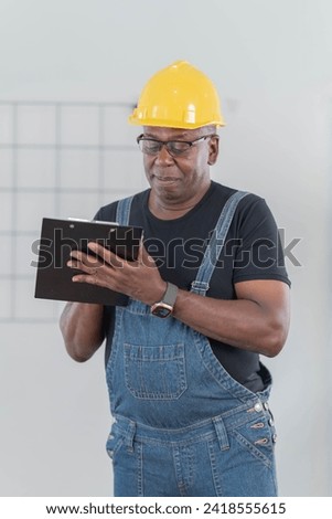 Professional of man architect industrial engineer Standing in the office, foreman in helmet using laptop working with new construction project architectural plan.