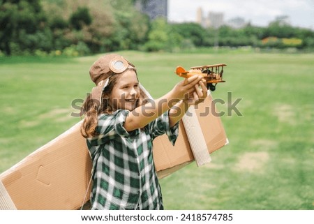 Happy child playing against in park and sky background. Kid pilot having fun outdoors. Summer vacation and travel concept. Freedom and imagination, concept inspiration
