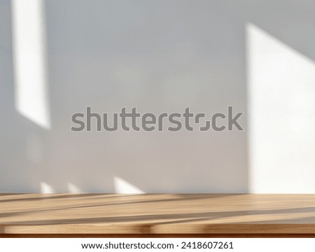 Empty of wood table top on abstract White concrete wall with  sunlight shadow reflected. For montage product design display mockup