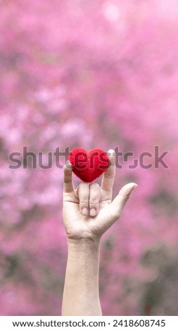 young man raises his hand and makes sign language symbol of "I love you" show love and friendship for each other. Sign language is also universal language that can be easily understood as saying love.