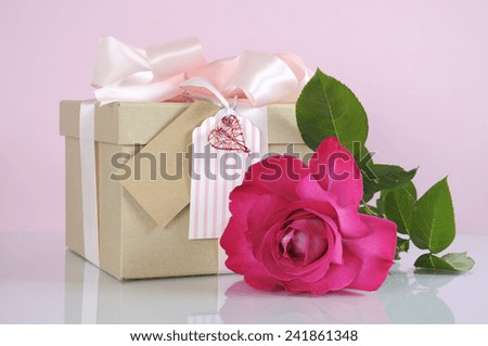 Beautiful classic kraft paper cardboard gift box with pale pink ribbon and rose