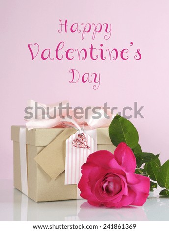 Beautiful classic kraft paper cardboard gift box with pale pink ribbon and rose, with Happy Valentines Day sample text greeting message.