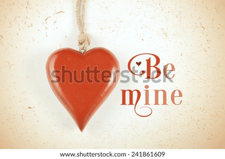 Happy Valentines Day retro vintage grunge style hanging red wood heart with Be Mine sample text greeting message.
