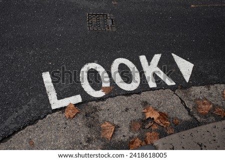 Look sign stencil on asphalt