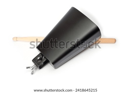 Cowbell percussion musical instrument, black metal with a wooden stick. Royalty-Free Stock Photo #2418645215