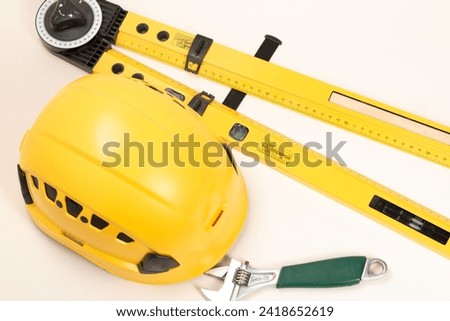 Construction concept. Yellow safety helmet, construction sites. Business and industry concept. Copy space for design.Helmet with construction tools on white background

 Royalty-Free Stock Photo #2418652619