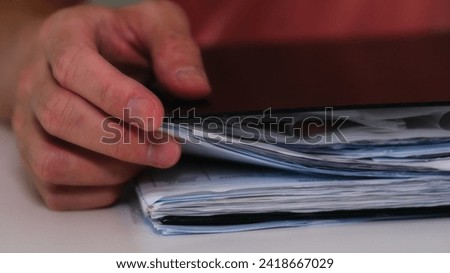 businessman hand working with a document folder in concept of document management system