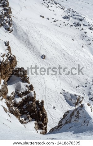 Ski resort in the Dolomites. Mountain recreation place. Ski slopes in the Dolomites on a clear sunny day. Alpine skiing sport and recreation. Snowboard track Royalty-Free Stock Photo #2418670595