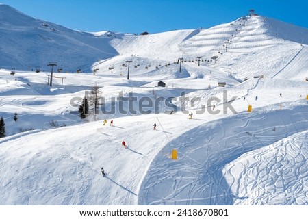 Ski resort in the Dolomites. Mountain recreation place. Ski slopes in the Dolomites on a clear sunny day. Alpine skiing sport and recreation. Royalty-Free Stock Photo #2418670801