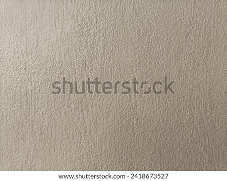 Beige cement walls, rough surface, not flashy color. Easy on the eyes.