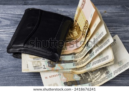 Russian paper money sticking out of the wallet, financial literacy, Russian economy.