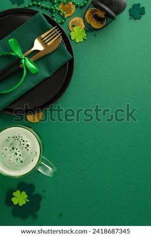 Pub vibes on St. Patrick's: Vertical top view black plate, napkin-clad utensils, beer-filled glass, gold coins in pot, trefoils, and beads against lively green setting. Great for your festive content